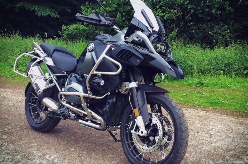 BMW R 1200 GS Adventure Motorrad auf einem Waldweg – geländetaugliche Reise-Enduro mit Sturzbügeln, Windschild und Speichenrädern für Offroad-Abenteuer.